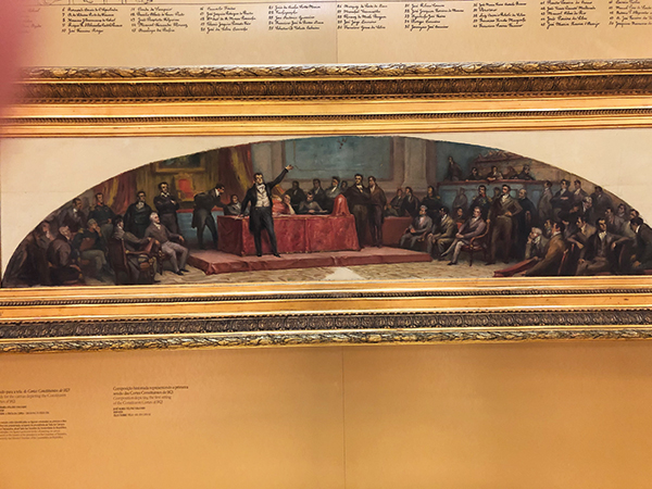Quadro com desenho de constitucionalistas, é cimeiro da Mesa da Assembleia da República, vendo-se João Baptista Felgueiras sentado na mesa, o 1º à esquerda.